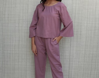 May include: A mauve-colored two-piece pajama set with a long-sleeved top and wide-leg pants.