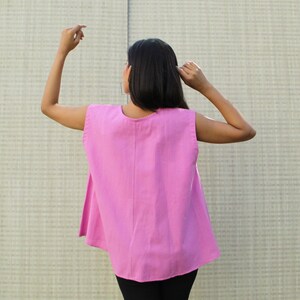 Model is wearing Round neck sleeveless Sexy Flared Crop Dusty Pink top with black formal pant