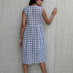 Model is wearing sleeveless Checks dress, Dress has V neckline. This is below knee length sexy dress. Wear this dress for any occasion. Simple, comfortable, Loungewear dress. Select any color and customize your dress of your choice