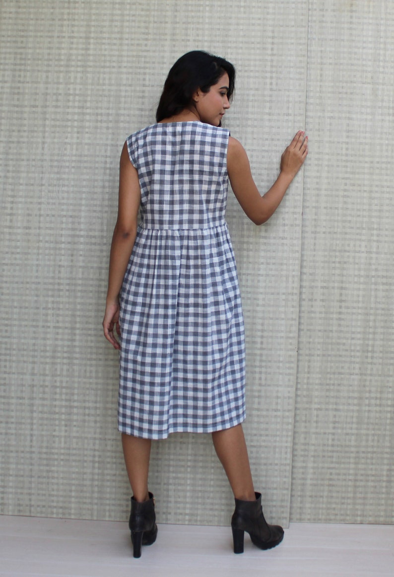 Model is wearing sleeveless Checks dress, Dress has V neckline. This is below knee length sexy dress. Wear this dress for any occasion. Simple, comfortable, Loungewear dress. Select any color and customize your dress of your choice