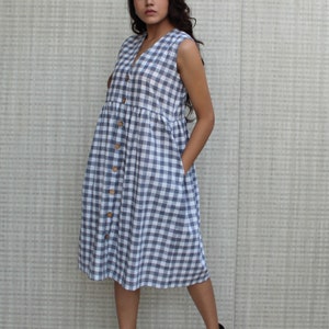 Model is wearing sleeveless Checks dress, Dress has V neckline. This is below knee length sexy dress. Wear this dress for any occasion. Simple, comfortable, Loungewear dress. Select any color and customize your dress of your choice