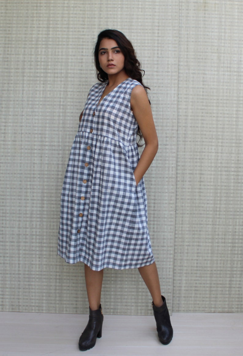 Model is wearing sleeveless Checks dress, Dress has V neckline. This is below knee length sexy dress. Wear this dress for any occasion. Simple, comfortable, Loungewear dress. Select any color and customize your dress of your choice