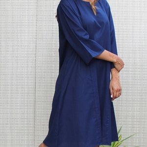 Model is wearing full sleeves blue color dress, Dress has split neck. This is knee length sexy dress. Wear this dress for any occasion. Simple, comfortable, Loungewear dress. Select any color and customize your dress of your choice