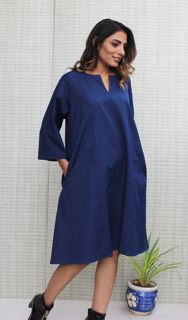 Model is wearing full sleeves blue color dress, Dress has split neck. This is knee length sexy dress. Wear this dress for any occasion. Simple, comfortable, Loungewear dress. Select any color and customize your dress of your choice