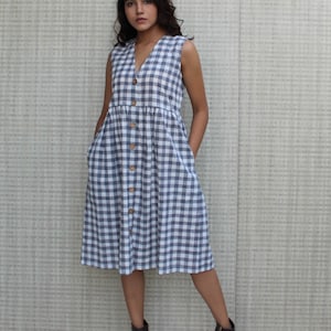 Model is wearing sleeveless Checks dress, Dress has V neckline. This is below knee length sexy dress. Wear this dress for any occasion. Simple, comfortable, Loungewear dress. Select any color and customize your dress of your choice