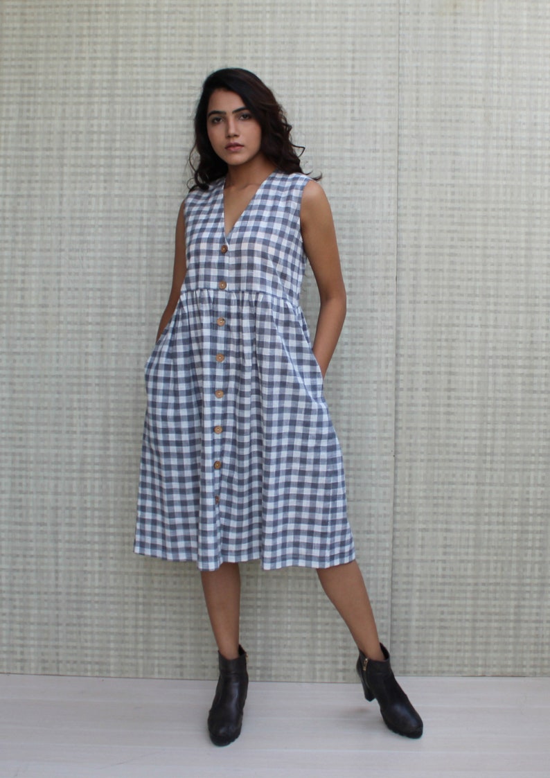 Model is wearing sleeveless Checks dress, Dress has V neckline. This is below knee length sexy dress. Wear this dress for any occasion. Simple, comfortable, Loungewear dress. Select any color and customize your dress of your choice