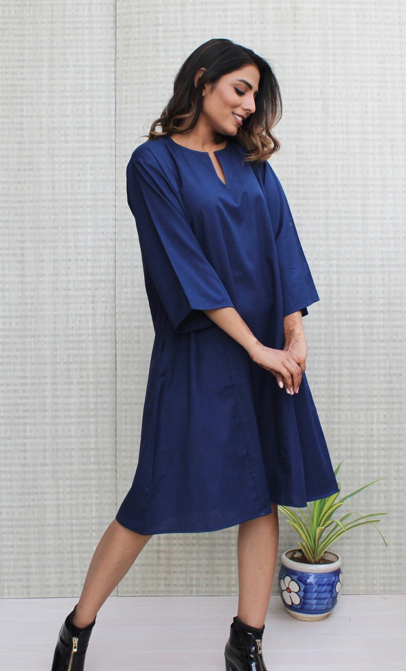 Model is wearing full sleeves blue color dress, Dress has split neck. This is knee length sexy dress. Wear this dress for any occasion. Simple, comfortable, Loungewear dress. Select any color and customize your dress of your choice