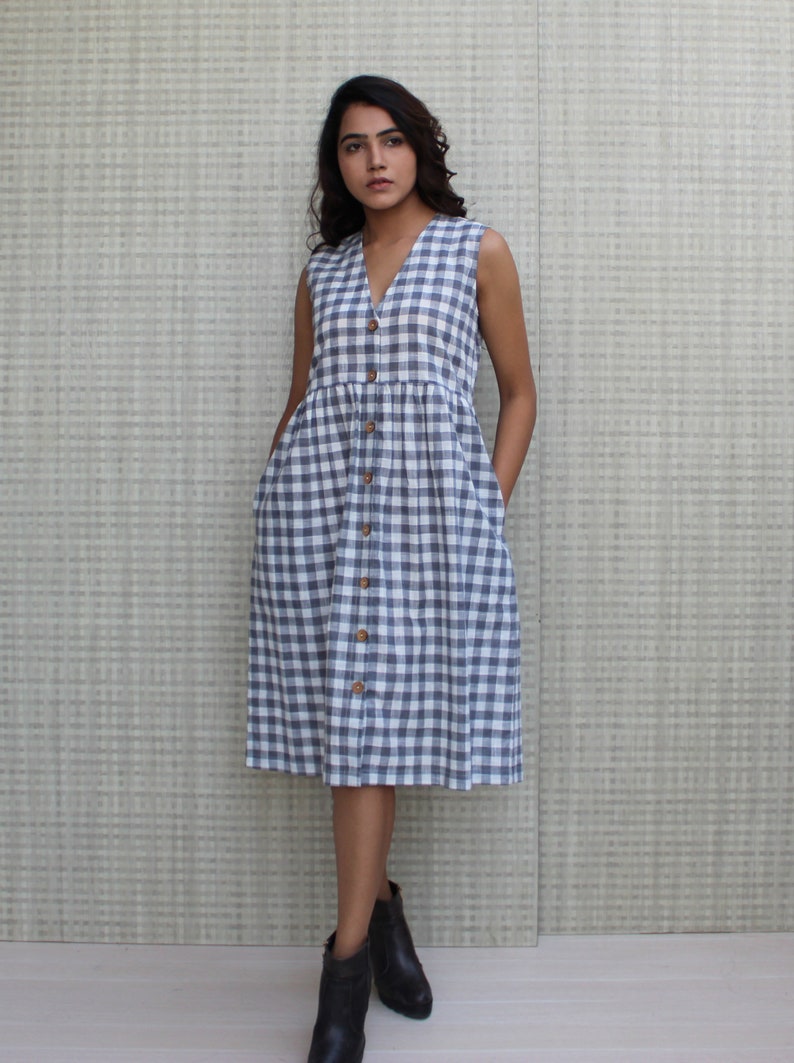 Model is wearing sleeveless Checks dress, Dress has V neckline. This is below knee length sexy dress. Wear this dress for any occasion. Simple, comfortable, Loungewear dress. Select any color and customize your dress of your choice