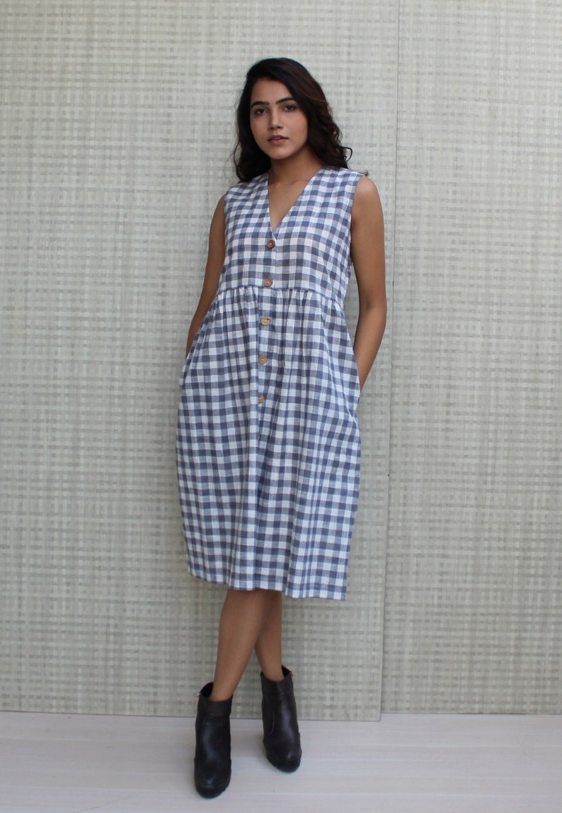 Model is wearing sleeveless Checks dress, Dress has V neckline. This is below knee length sexy dress. Wear this dress for any occasion. Simple, comfortable, Loungewear dress. Select any color and customize your dress of your choice