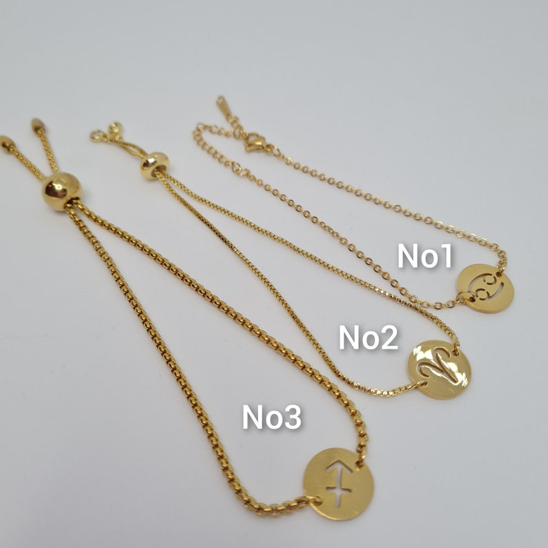 May include: Three gold adjustable bracelets with different zodiac signs. The first bracelet has the symbol for Cancer, the second bracelet has the symbol for Virgo, and the third bracelet has the symbol for Sagittarius.