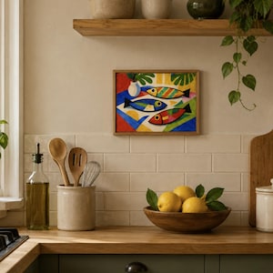 May include: A colorful framed artwork depicting three stylized fish in red, blue, and yellow. The kitchen scene includes a wooden cutting board, a bowl of lemons, and various kitchen utensils. A small potted plant sits on the windowsill.