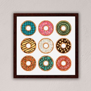 May include: A framed print featuring nine colourful doughnuts with various toppings, such as sprinkles, chocolate, and icing. The doughnuts are displayed in a 3x3 grid.