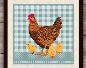 May include: A framed cross-stitch embroidery featuring a brown hen with a red comb and three yellow chicks. The design is set against a light blue and white checkered background with a dotted blue border at the bottom, all in a dark wood frame.