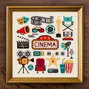 May include: A framed cross-stitch pattern featuring cinema-themed icons including a marquee sign with the text CINEMA, a film reel, a director's chair, a golden statue, a clapperboard, 3D glasses, a megaphone, a star, popcorn, and a camera.