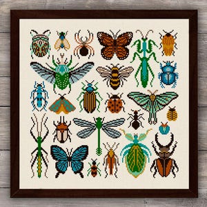 May include: A framed cross-stitch embroidery featuring a grid of various colorful insects, including butterflies, beetles, a praying mantis, a dragonfly, and a spider, all rendered in a pixelated style on a light-colored fabric background.