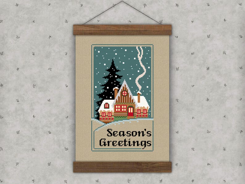 Cross-stitch pattern featuring a vintage Christmas scene of a house with a chimney on a starry night and the text "Season's Greetings."