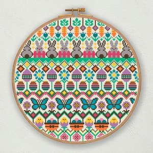 May include: A colourful cross-stitch pattern with a repeating design of bunnies, eggs, butterflies, and flowers. The pattern is framed in a wooden hoop.