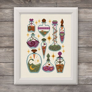 May include: A collection of nine glass bottles with various colored liquids and decorative elements, including hearts, stars, and vines. The bottles are arranged in a symmetrical pattern on a cream-colored background.