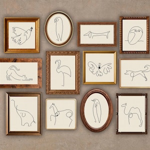 Könnte beinhalten: Eine Sammlung gerahmter Kunstwerke mit minimalistischen Strichzeichnungen verschiedener Tiere, darunter eine Taube, eine Eule, ein Hund und ein Elefant. Die Rahmen sind in verschiedenen Formen und Farben, darunter Gold und Braun, vor neutralem Hintergrund.