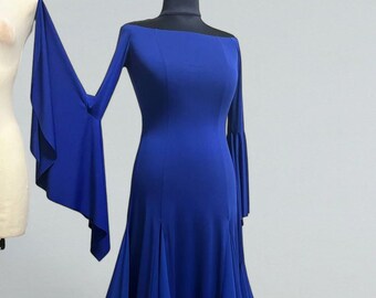 May include: A royal blue off-the-shoulder gown with long bell sleeves and a flowing skirt. The skirt has a black mesh trim at the hem.