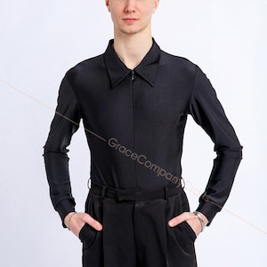 May include: A black long-sleeved shirt with a zipper closure and a collar. The shirt is made of a smooth, silky fabric.