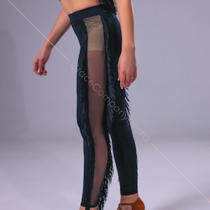 May include: Black dance leggings with fringe detail and a sheer panel on the side. The leggings are paired with brown dance shoes.