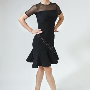 May include: A black dance dress with a mesh top and a ruffled skirt. The dress is fitted and has short sleeves.