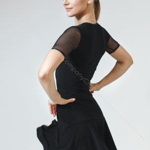 May include: A black dance dress with a mesh short sleeve top and a flared skirt.