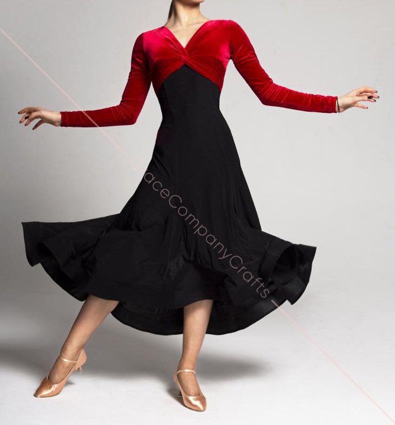May include: A black and red dance dress with a long, flowing skirt and a fitted bodice. The bodice has a red velvet top with a twist detail and a black skirt.