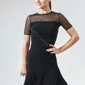 May include: A black dance dress with a mesh top and a flared skirt. The dress has short sleeves and a round neckline.
