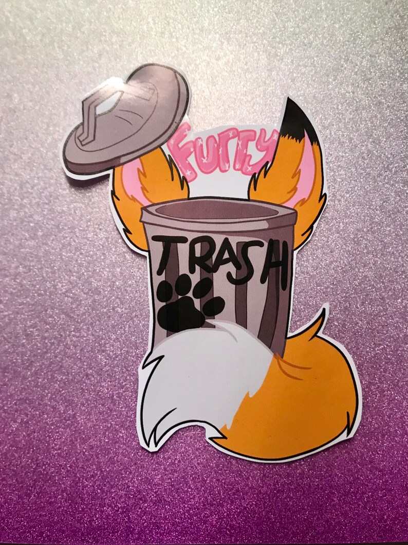 May include: A gray trash can with a black paw print and the word "TRASH" written on it. The trash can is surrounded by a cartoon fox's ears and tail. The word "Furry" is written above the trash can.
