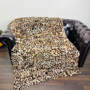 Luxurious rabbit fur blanket draped over sofa