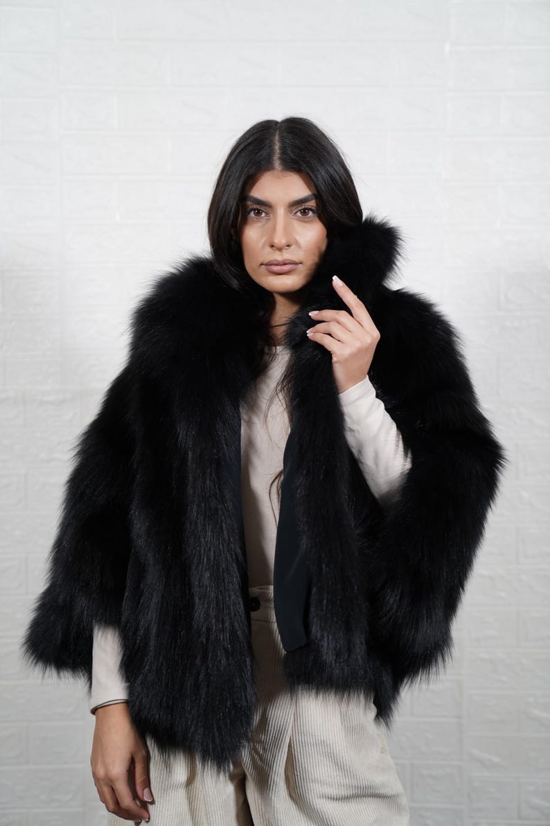 Close up detail of genuine fox fur texture showing soft premium quality pelts used in handmade artisan fur coat