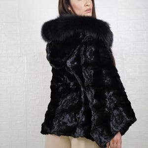 Elegant mink fur outerwear with a sleek, stylish design, perfect for cold weather outings.