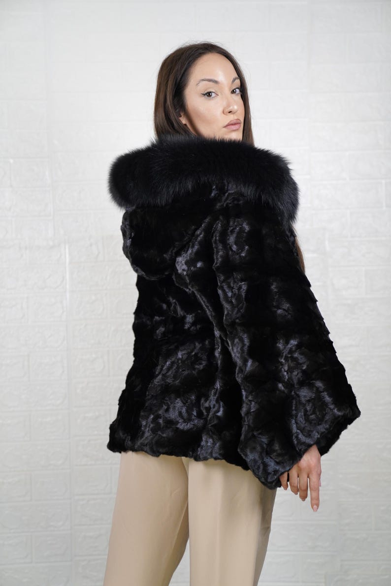 Elegant mink fur outerwear with a sleek, stylish design, perfect for cold weather outings.