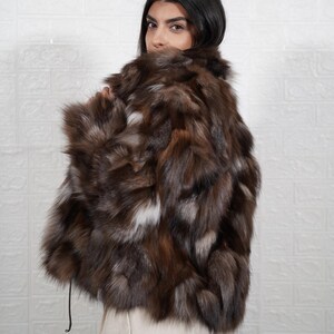Detailed view of fox fur coat collar and closure, showing artisan craftsmanship and premium fur quality of handmade jacket