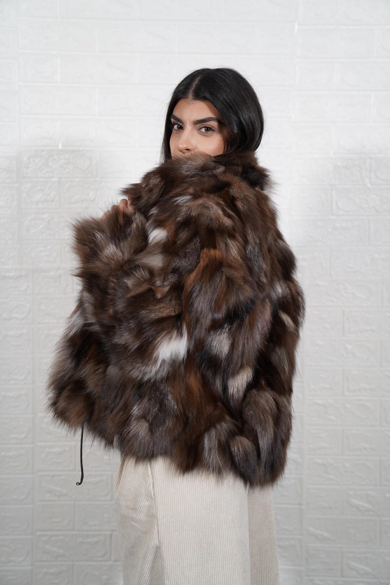 Detailed view of fox fur coat collar and closure, showing artisan craftsmanship and premium fur quality of handmade jacket