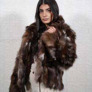 Woman wearing elegant handmade fox fur coat, luxury real fur jacket for winter formal occasions and evening events