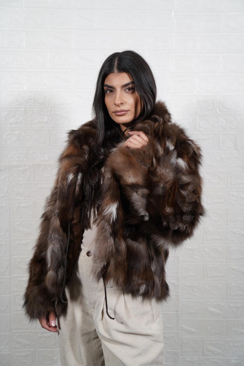 Woman wearing elegant handmade fox fur coat, luxury real fur jacket for winter formal occasions and evening events