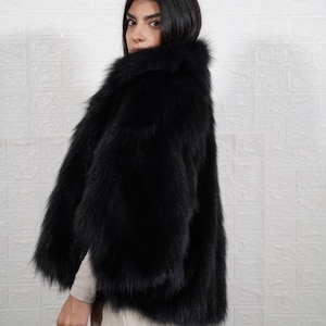 Woman wearing elegant handmade fox fur coat, luxury real fur jacket for winter formal occasions and evening events