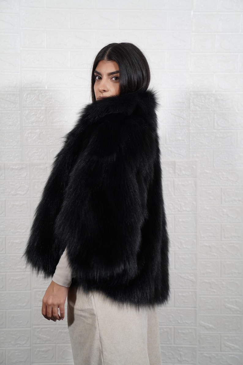 Woman wearing elegant handmade fox fur coat, luxury real fur jacket for winter formal occasions and evening events