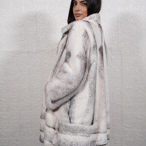 Side profile natural black cross mink fur overcoat long length elegant silhouette luxury women coat pockets