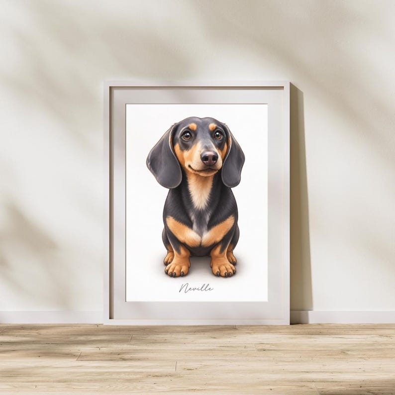 May include: A framed wall art print featuring a digital illustration of a black and tan dachshund sitting upright. The dog has long floppy ears and brown eyes. Below the dog, the name Neville is printed in a cursive black script font.