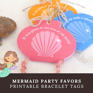 May include: Seashell-shaped party favor tags in pink, blue, and orange, with text, "It was great to sea you at my party!" and "Helping me make a splash!" A mermaid illustration is in the corner. The tags are attached to bracelets.