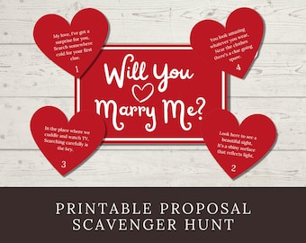 以下が含まれることがあります： Will You Marry Meという白い文字とハートのアイコンが描かれた赤い長方形の看板と、1から4までの番号が振られた4枚の赤いハート型のカード。それぞれのカードには、プロポーズのための宝探しゲームのヒントとなる韻を踏んだ文章が書かれています。