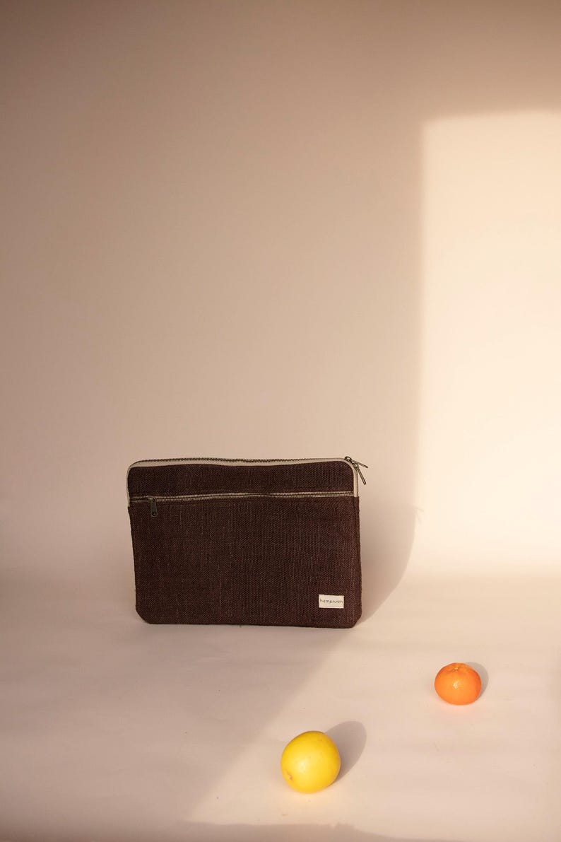 Eco-friendly hemp laptop sleeve in  Brown , designed to fit 13-inch and 15-inch laptops. Features a minimalist, sustainable design with two spacious compartments for accessories.