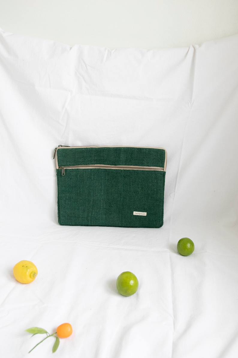 Eco-friendly hemp laptop sleeve in  green, designed to fit 13-inch and 15-inch laptops. Features a minimalist, sustainable design with two spacious compartments for accessories.