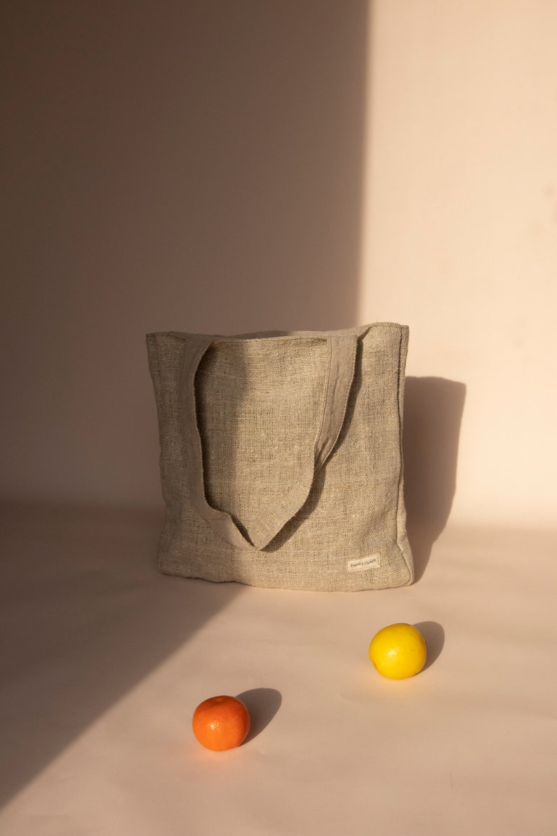 Eco-friendly natural hemp tote bag in beige, featuring a spacious design with durable handles. Perfect for zero-waste shopping, daily errands, or casual outings