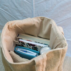 Close-up of the natural hemp fabric on the tote bag, highlighting the what can fit inside the spacious tote bag