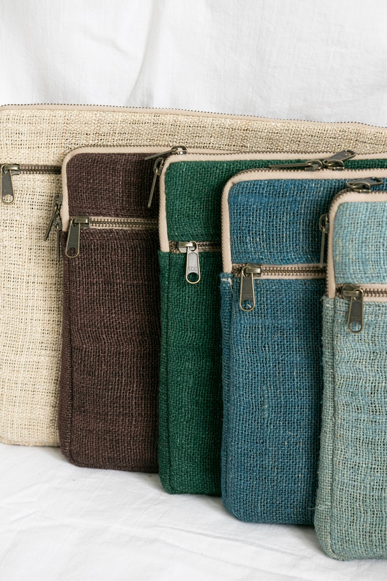 Eco-friendly hemp laptop sleeve in natural beige, blue, pink, green and light blue, designed to fit 13-inch and 15-inch laptops. Features a minimalist, sustainable design with two spacious compartments for accessories.